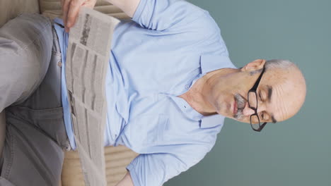 Vertical-video-of-The-old-man-reading-the-newspaper.